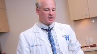 Cardiologist talks to heart patient who is an athlete